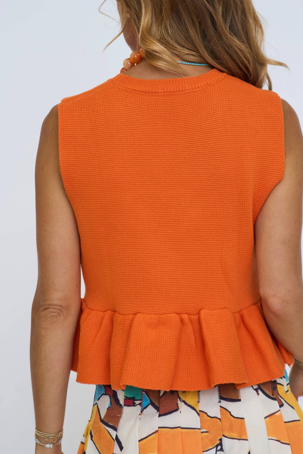 Solid Sleeveless Micro Knit Peplum Top In Burnt Orange